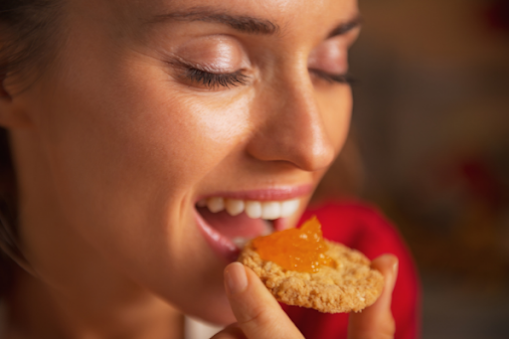 woman-eating-cookie-smiling